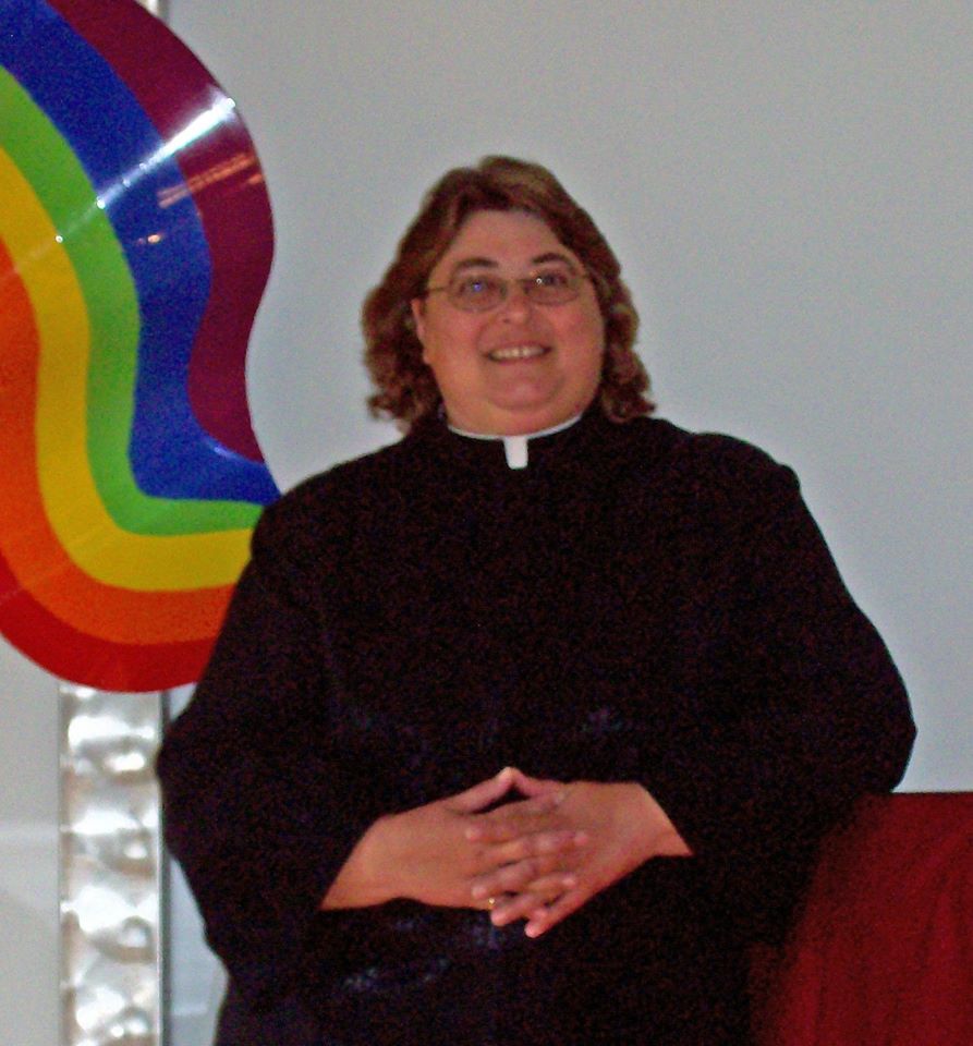 Margaret Hawk in front of the rainbow cross